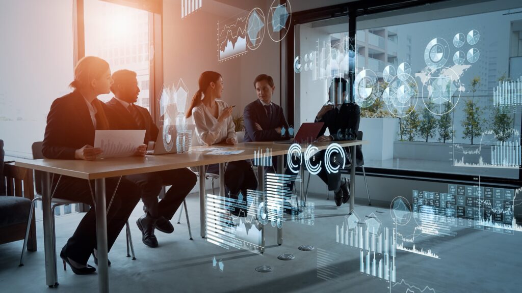 Business team discussing digital strategies with holographic data displays, showcasing managed cybersecurity services.