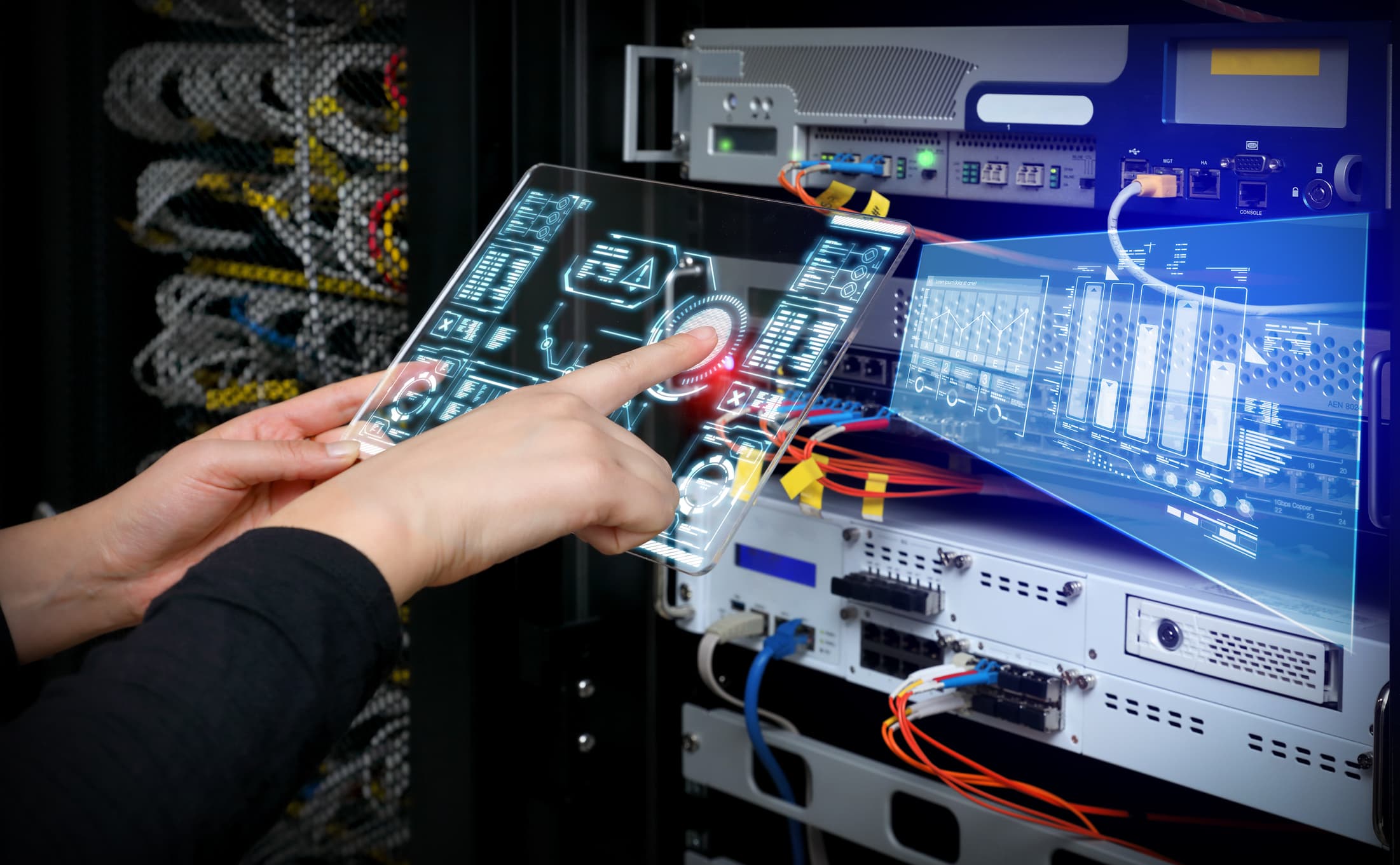 Technician using digital interface in a server room to showcase advanced managed network services.